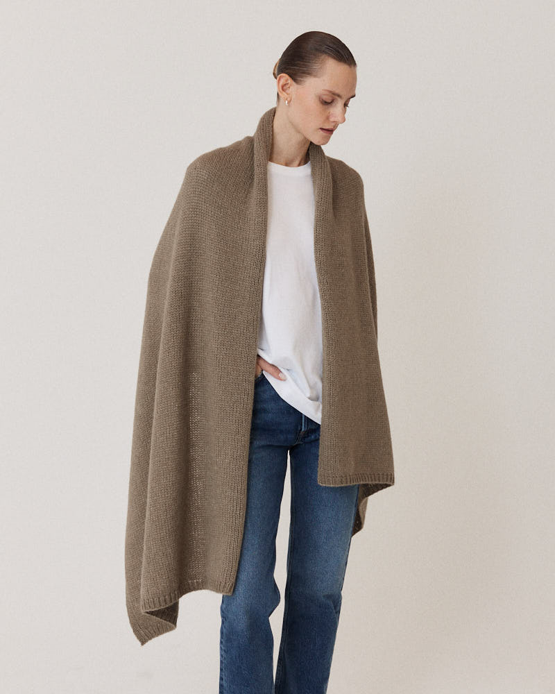 Model wearing olive stole knitted from alpaca wool