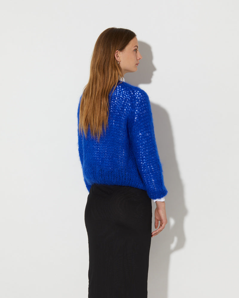 Back view of Maiami cardigan in blue.