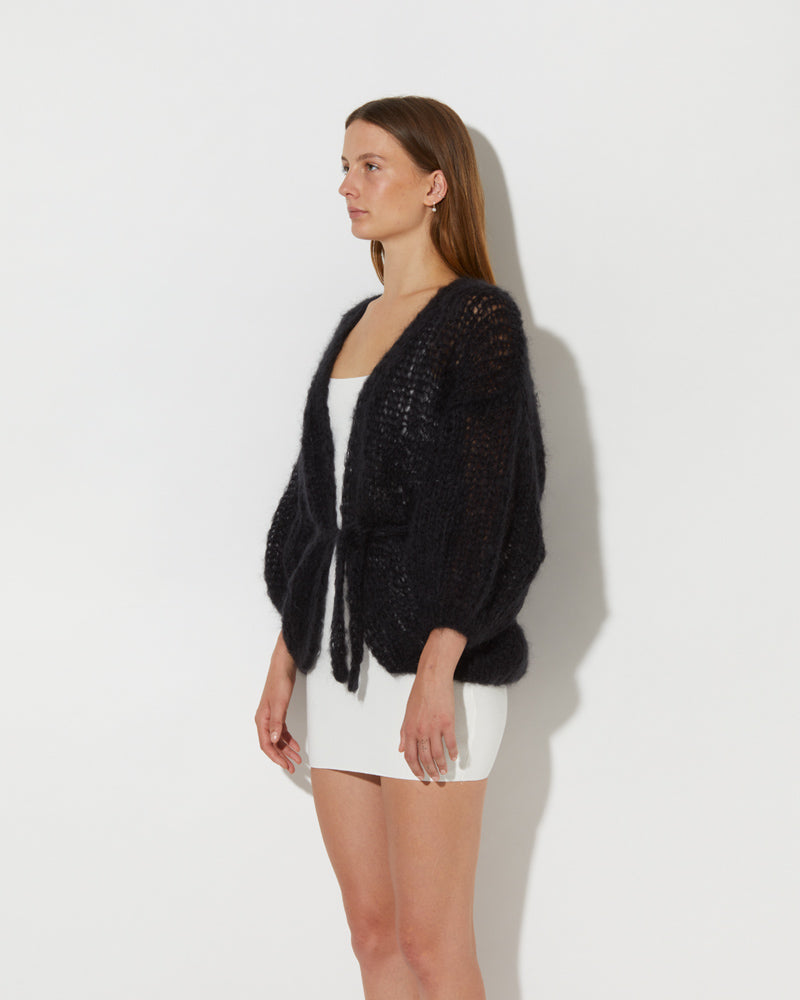 Side view of Model wearing the Mohair Oversized Cardigan Light. Mohair knit cardigan women.