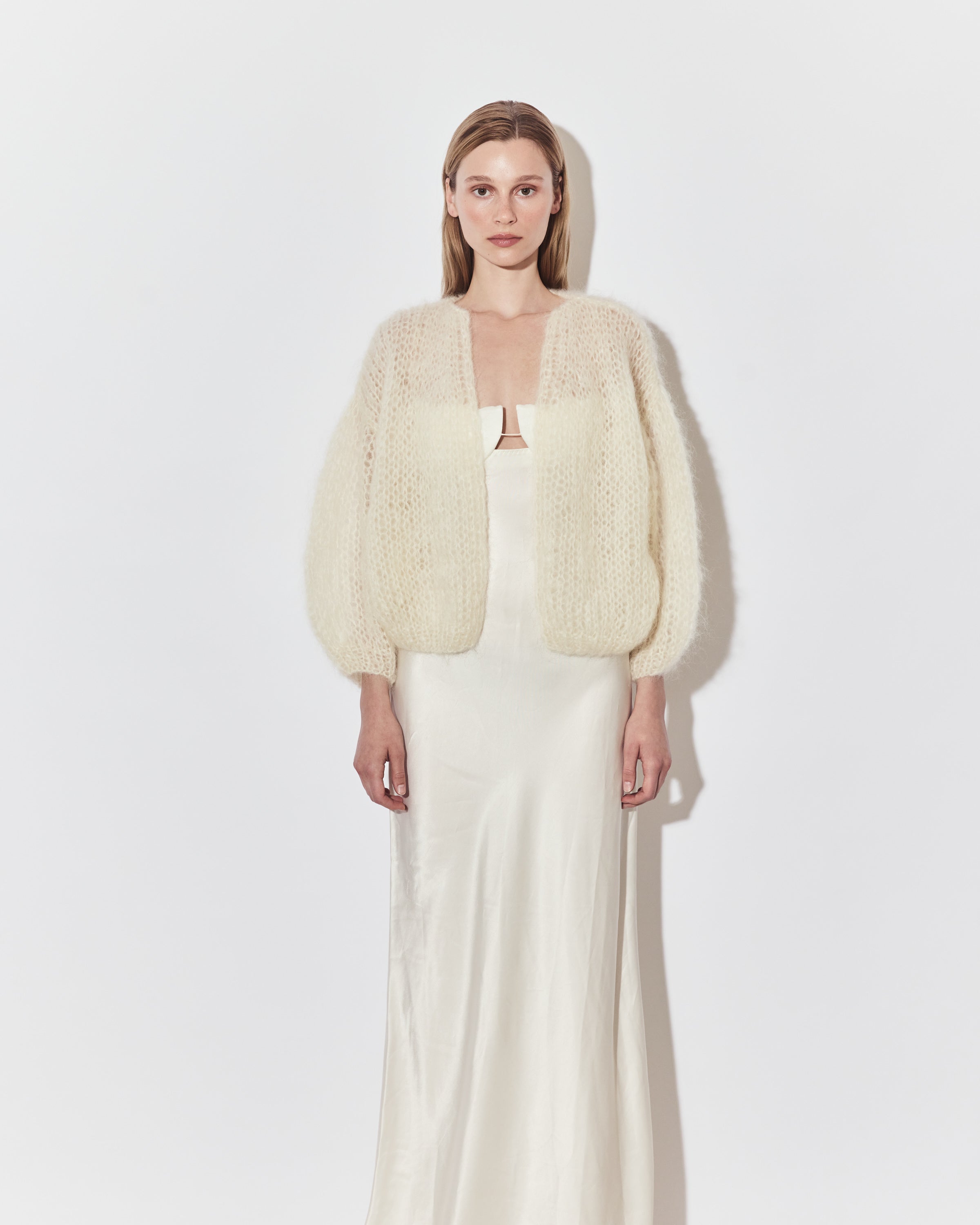 Maiami bridal knitwear layered over a minimalist wedding dress