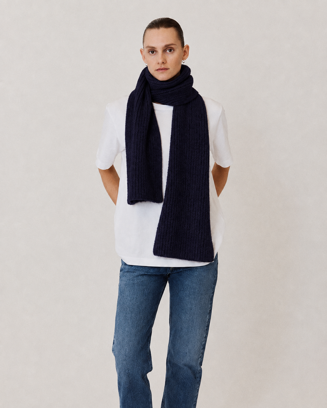 Model wearing navy knitted scarf