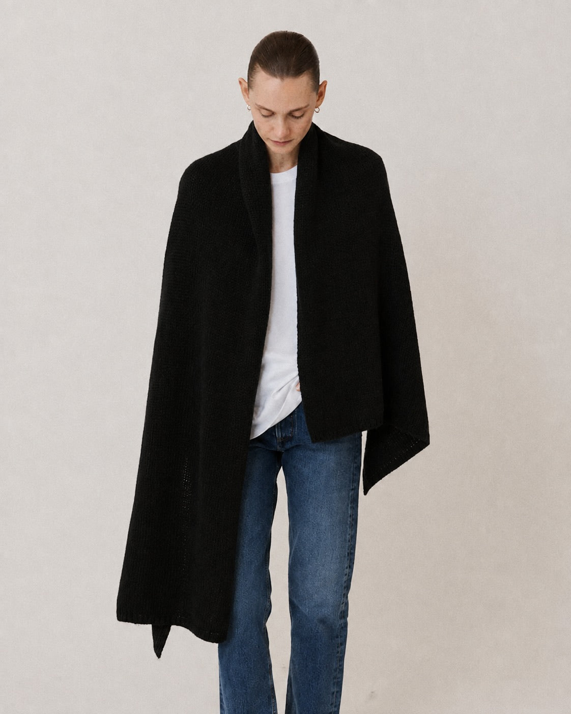 Model wearing black stole knitted from alpaca wool