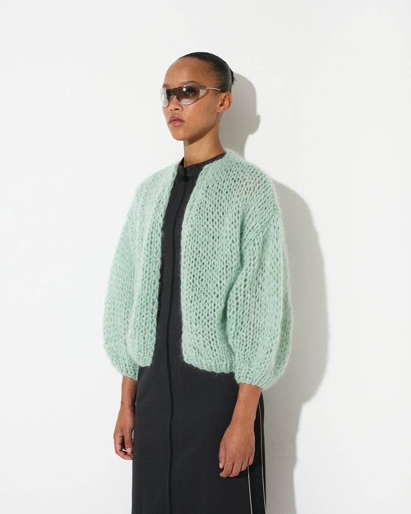 Model wearing lightweight mohair bomber cardigan, short and voluminous by Maiami, Spring 2025