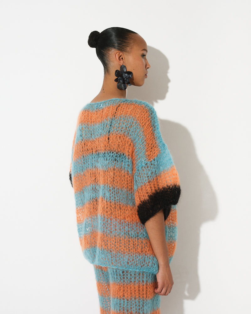 Model wearing long striped mohair t-shirt inspired by basketball jerseys, Spring 2025