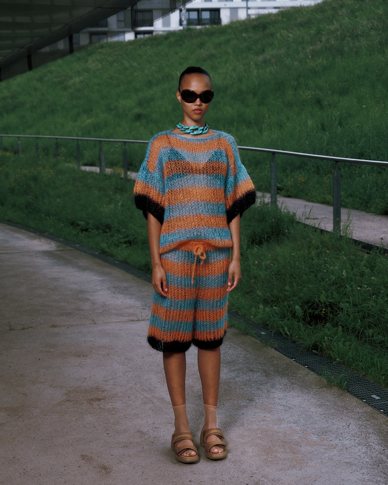 Model wearing long striped mohair t-shirt inspired by basketball jerseys, Spring 2025