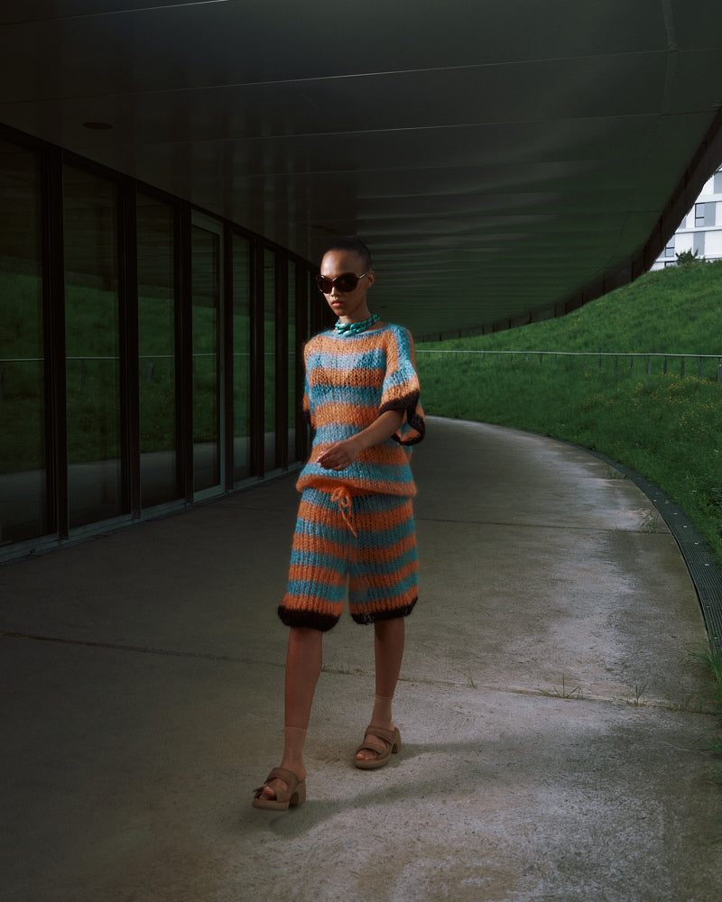 Model wearing long striped mohair t-shirt inspired by basketball jerseys, Spring 2025