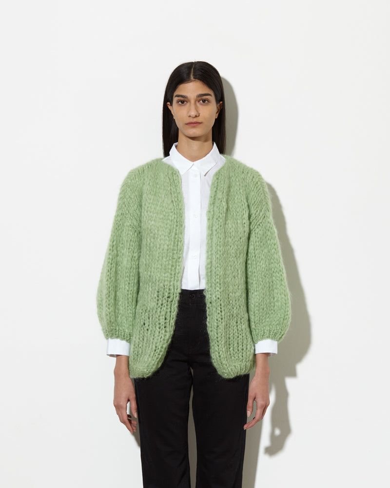 Model is wearing oversized Mohair Cardigan in pistachio from Maiami.