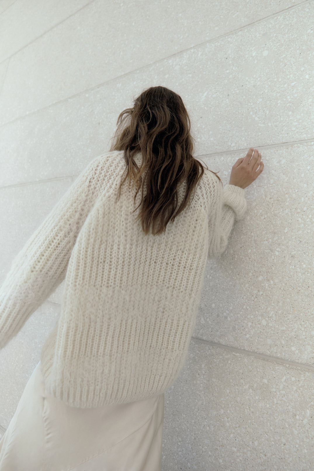 Model from the back wearing Alpaca Brioche Loose Fit Pullover in Creme