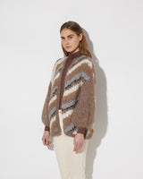 View from the side of model wearing the new in Alpaca Big Cardigan with diagonal stripes in the color 'Camel Grey'