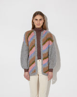 Frontal view of model wearing the new in Alpaca Big Cardigan with diagonal stripes in the color 'Strawberry Sky'