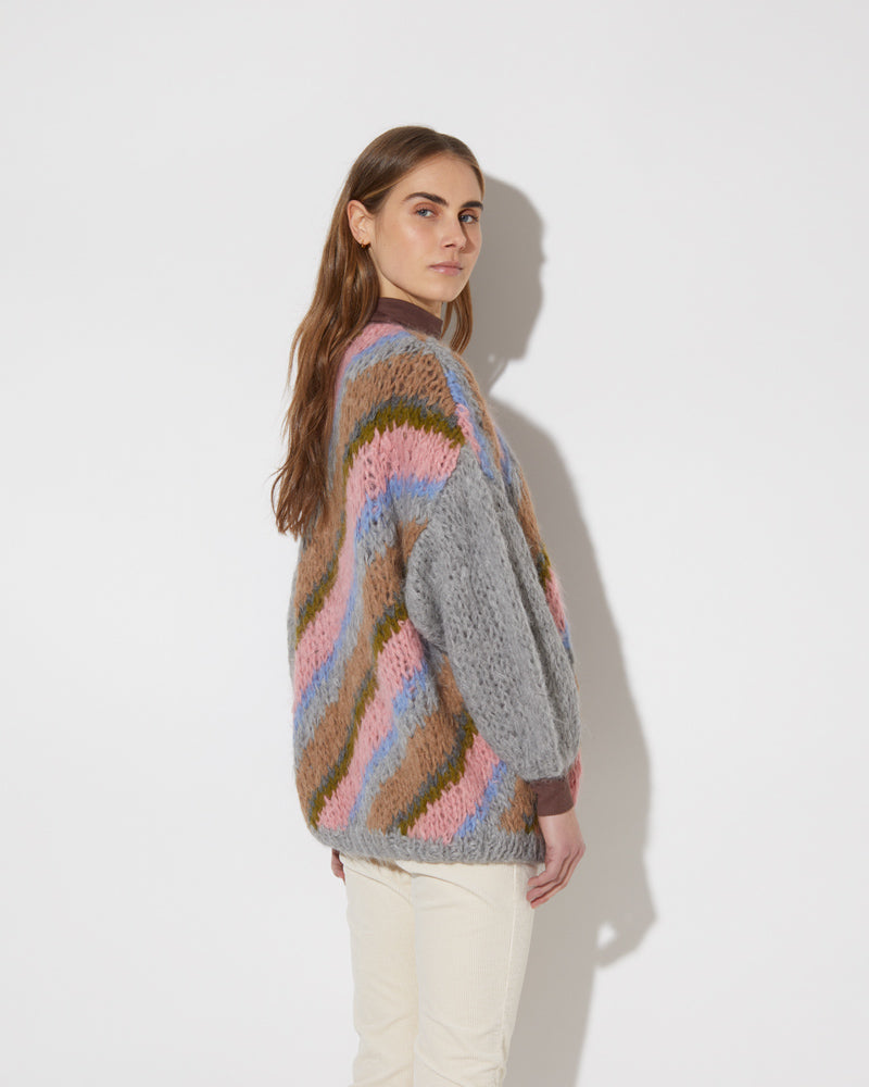 View from the back of model wearing the new in Alpaca Big Cardigan with diagonal stripes in the color 'Strawberry Sky'