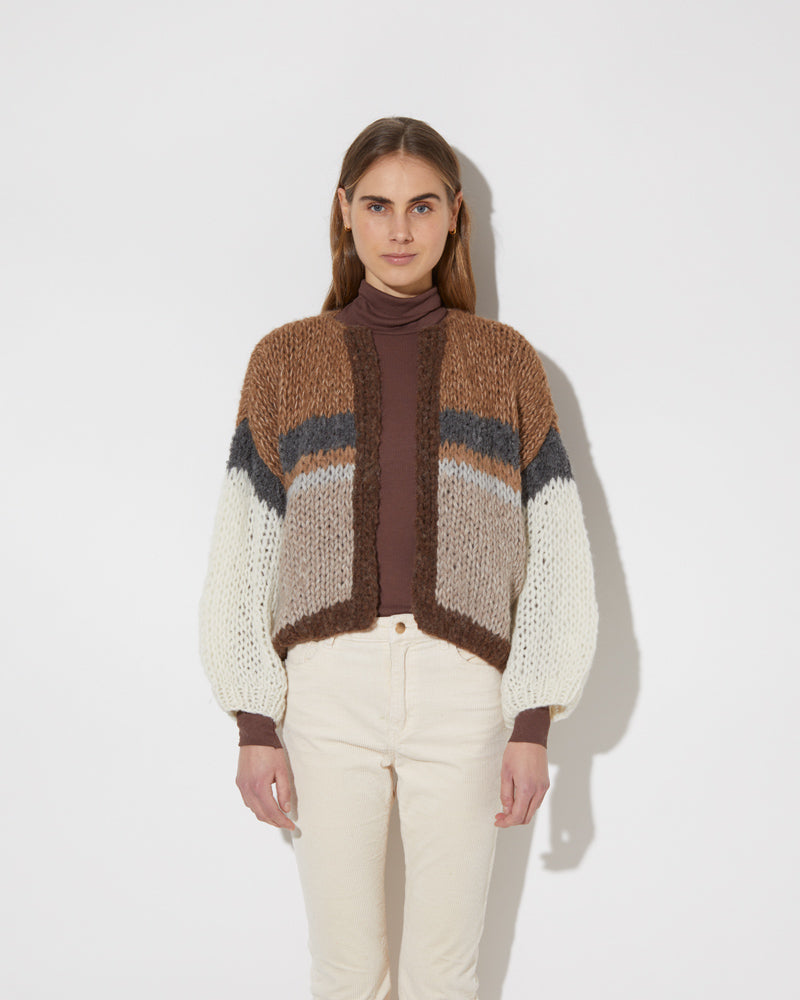 Frontal view of model wearing the new in Alpaca Mix Bomber Cardigan in the color 'Camel Stripes' with a trouser