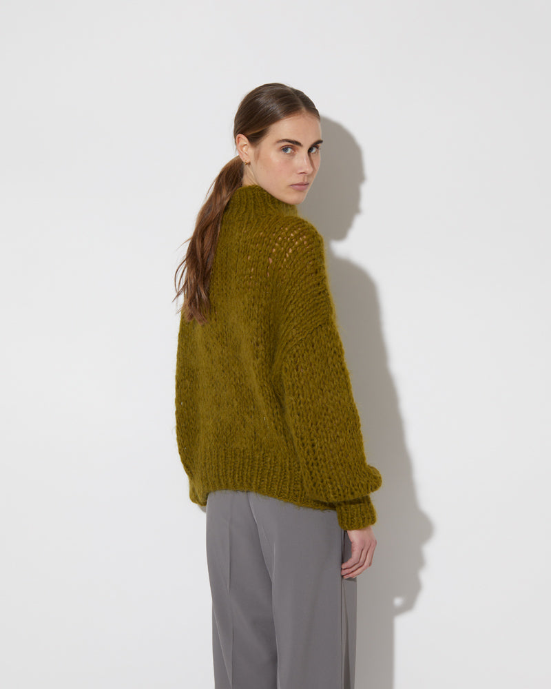 View from the back of model wearing the new in Alpaca Turtleneck Pullover in the color 'Khaki L509'