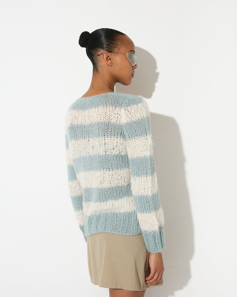 Model wearing a soft alpaca striped V-neck pullover with relaxed fit and horizontal stripes in light tones
