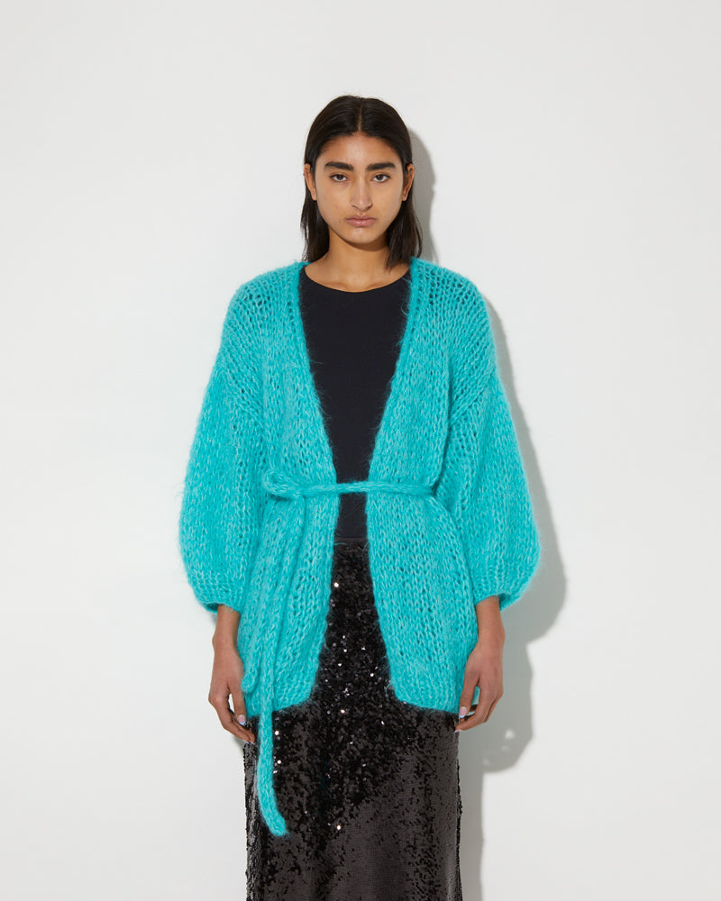 Model wearing Maiami Alpaca cardigan in mint green.