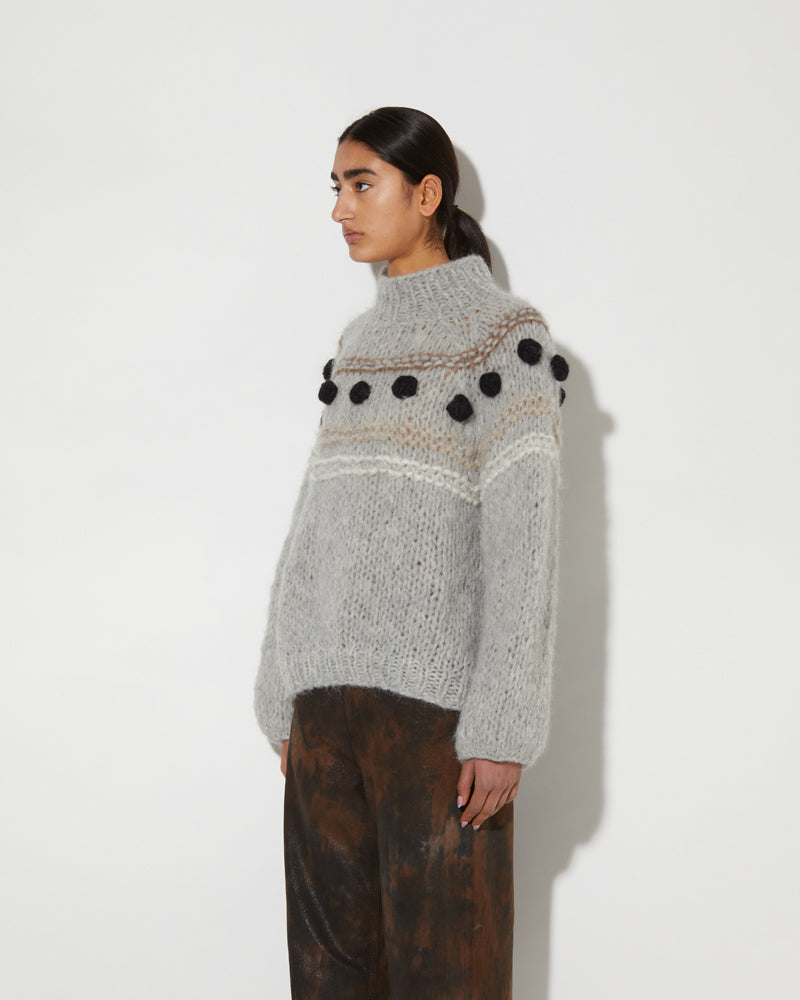 Side view of Maiami Alpaca sweater with black bobbles.