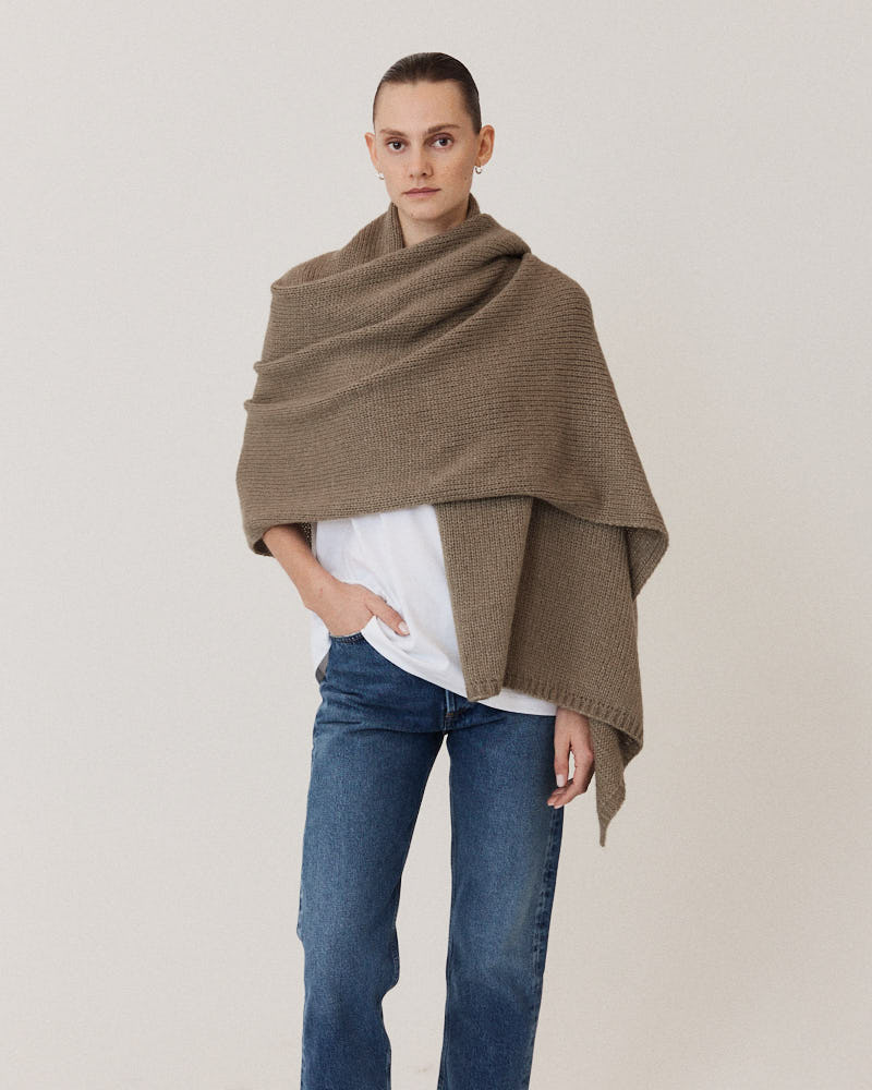 Model wearing olive stole knitted from alpaca wool
