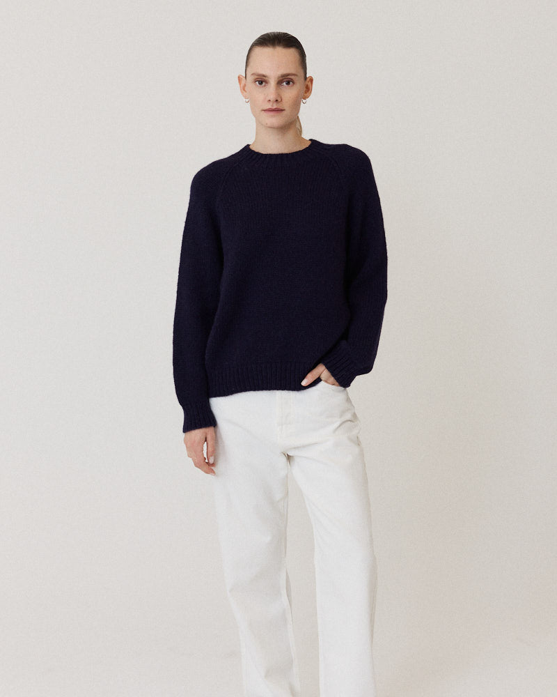 Model wearing navy crew neck knitted sweater