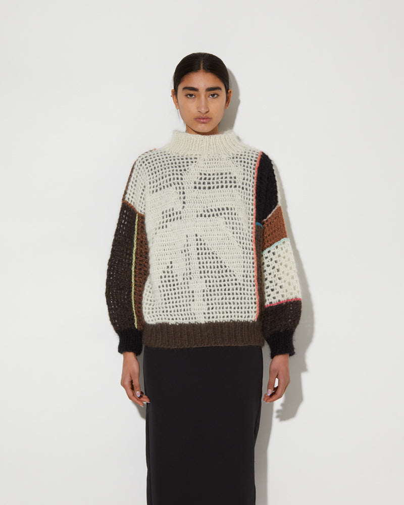 Front view of Maiami patchwork sweater with a palm tree.