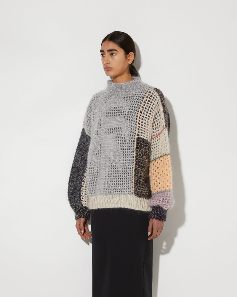 Side view of Maiami crochet pullover with a palm tree.