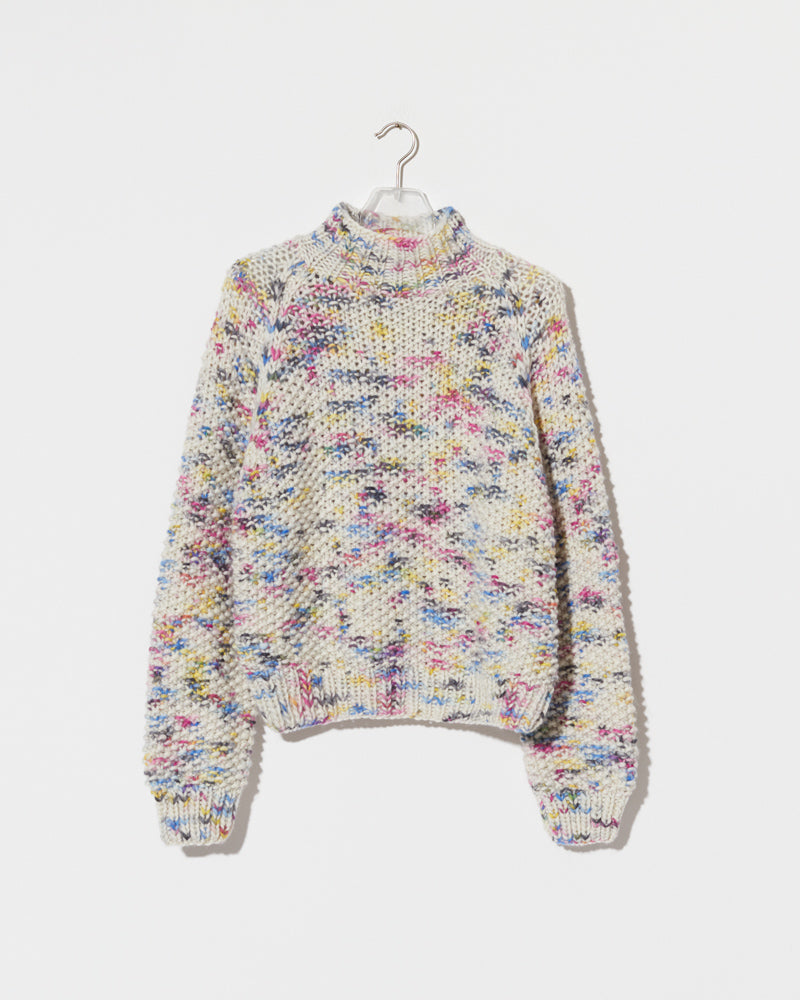 Structured hand-knitted pullover of merino wool in creme with colorful accents 