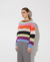 View from the side of model wearing the Gradient Fade Pullover in the color 'Cool Pastels'