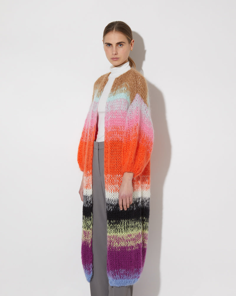 View from the side of model wearing the Gradient Fade Mohair Coat in the color 'Cool Pastels'