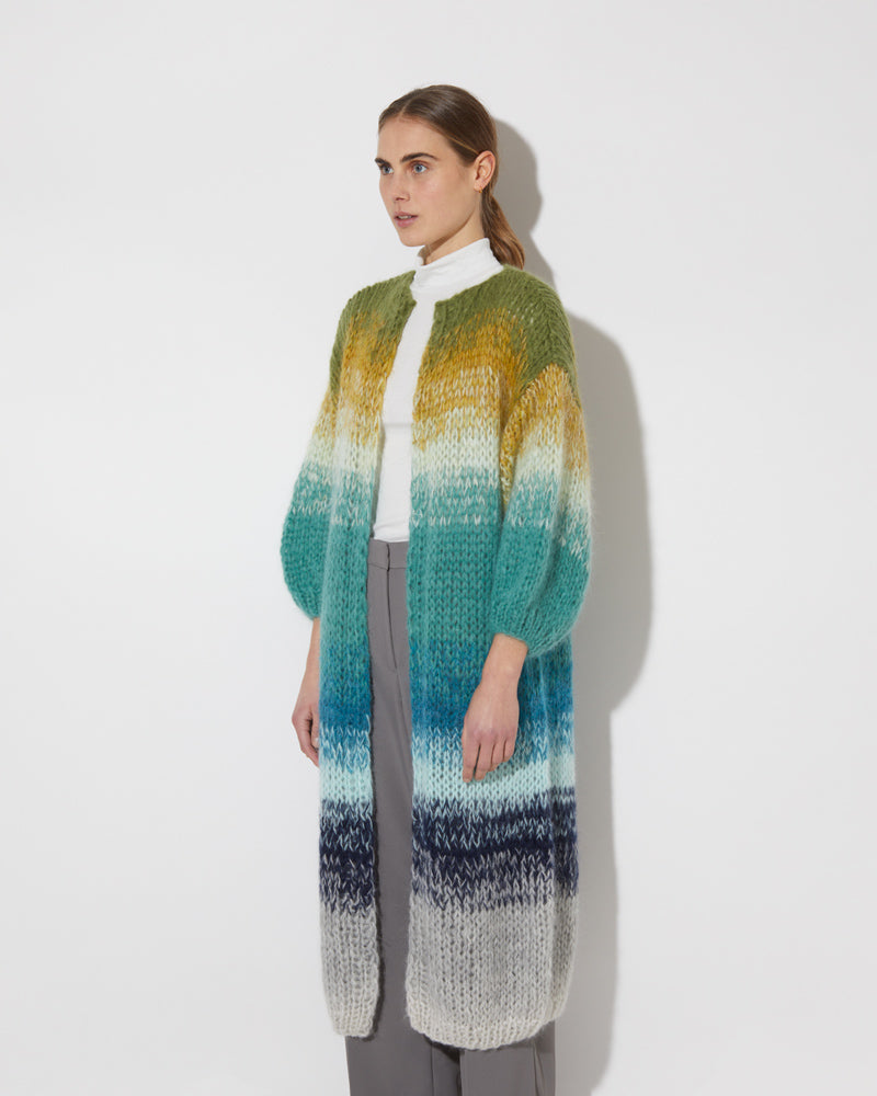 View from the side of model wearing the Gradient Fade Mohair Coat in the color 'Soft Fall'