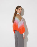 View from the back of model wearing the Gradient Fade Mohair Bomber Cardigan in the color 'Cool Pastel'