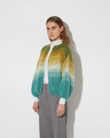 View from the side of model wearing the Gradient Fade Mohair Bomber Cardigan in the color 'Soft Fall'