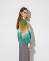 View from the back of model wearing the Gradient Fade Mohair Bomber Cardigan in the color 'Soft Fall'