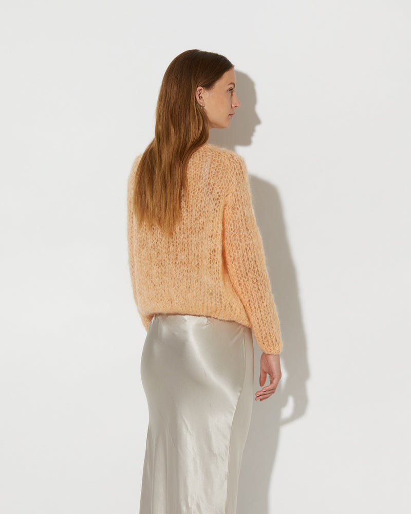 Side shot of Model wearing the Mohair Small Cardigan Light. Trendy mohair cardigan for women.