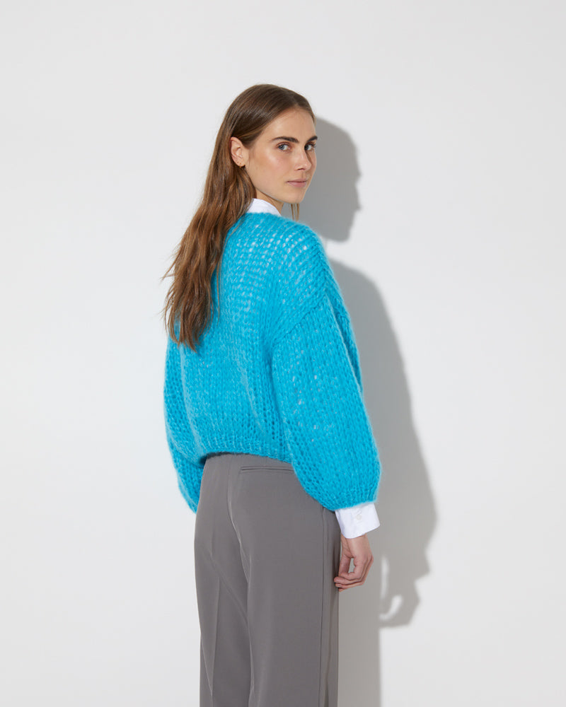 View from the back of model wearing the new in Mohair Big Bomber Cardigan in the new color 'Cyan 2445'