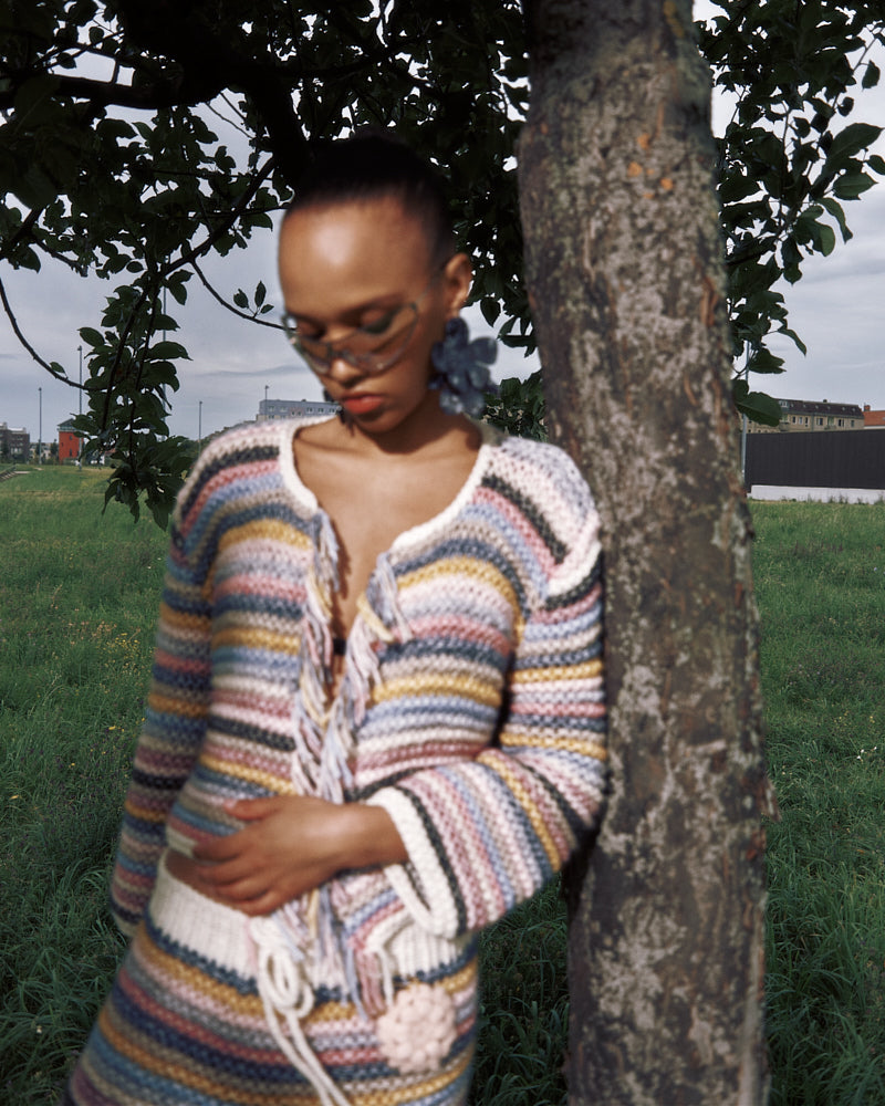 Model wearing cotton merino striped knit jacket by Maiami, Spring 2025