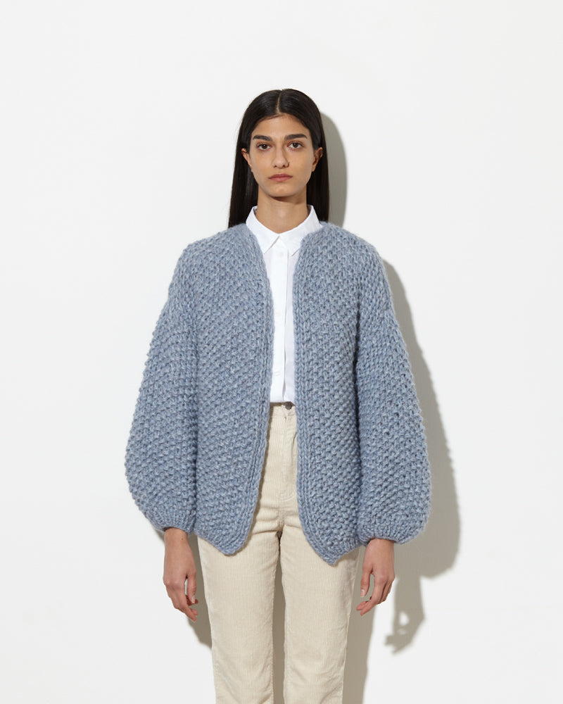 Model from the front wearing Alpaca cardigan in light blue.