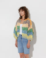 model wearing the spring boucle bomber cardigan in citric. Shot from the side