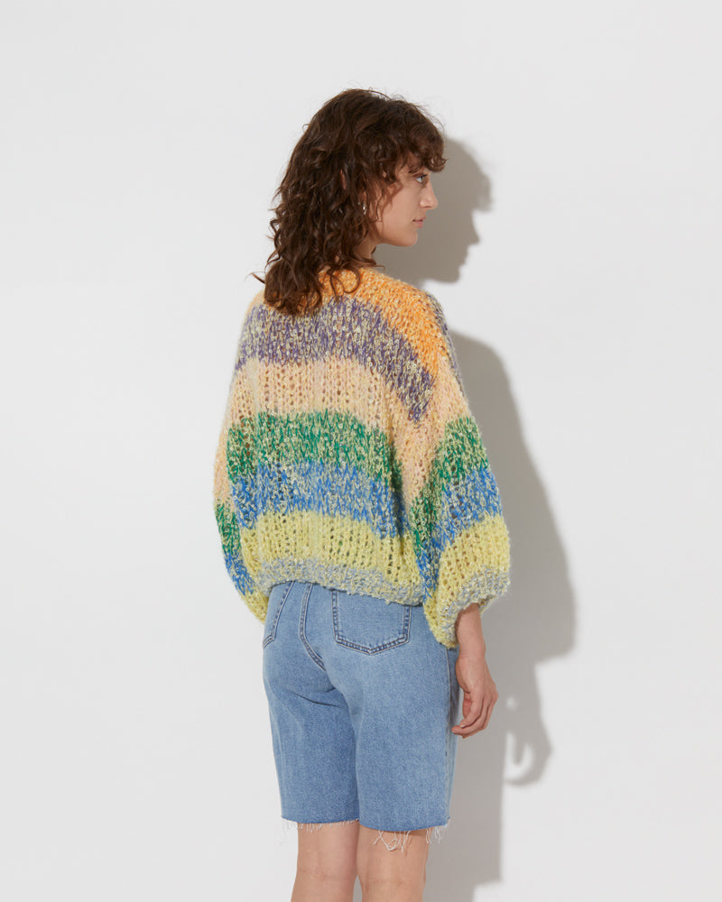 model wearing the spring boucle bomber cardigan in citric. Shot from the back