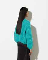 Model from the back wearing Cashmere cardigan women in the colour mint.