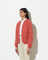 Model from the side wearing Cashmere cardigan women in the colour raspberry.