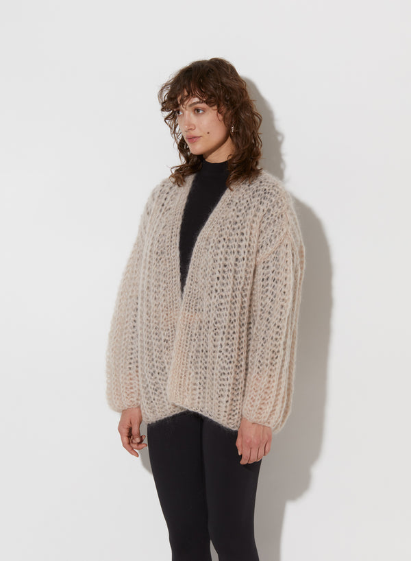 Model from the side wearing Chunky cardigan.