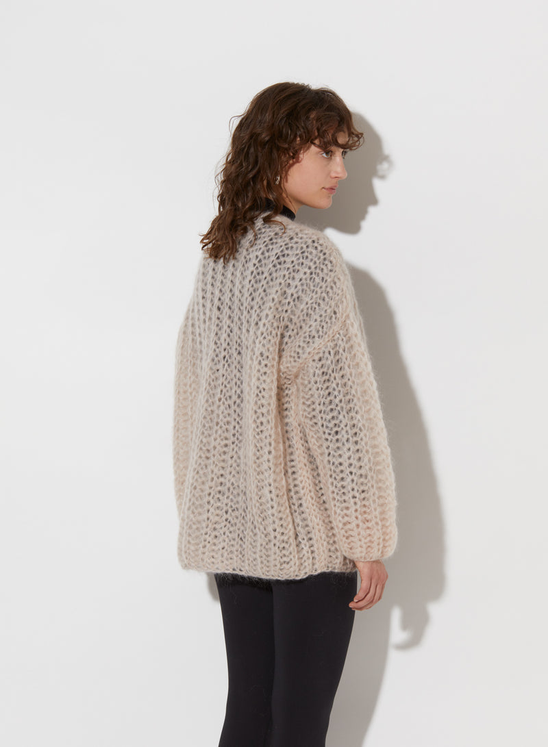 Model from the back wearing Chunky cardigan.