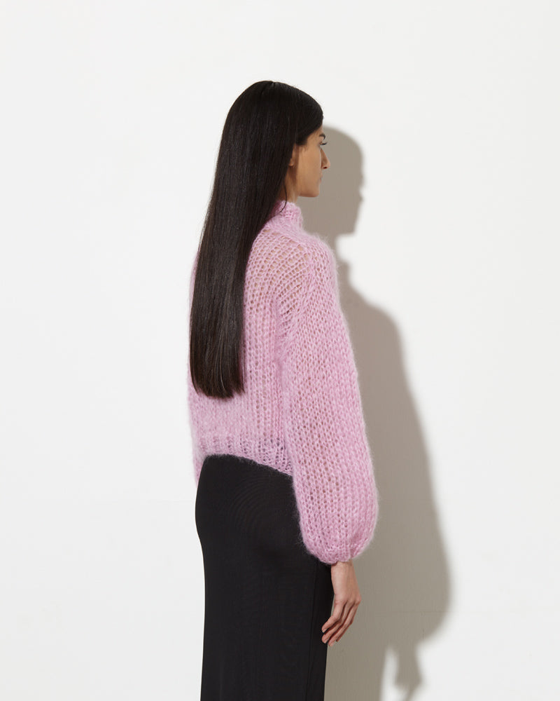 model from the back wearing Mohair turtleneck in rose. hand-knitted with love.