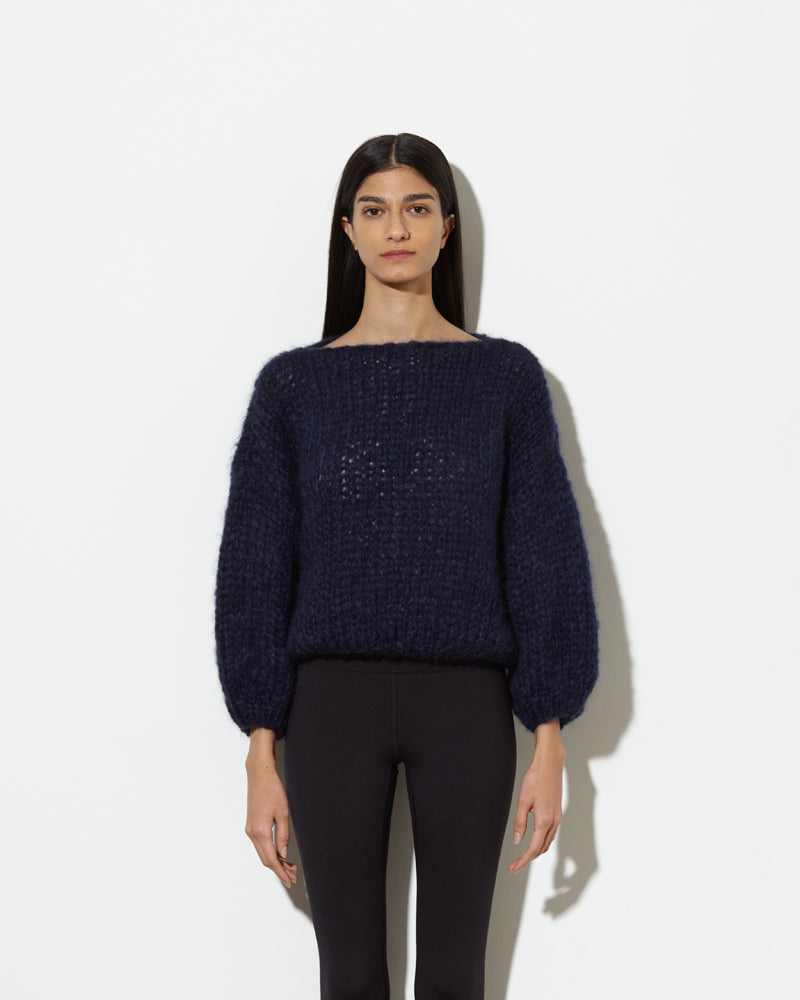 model wearing mohair sweater in navy. soft and cozy feel.