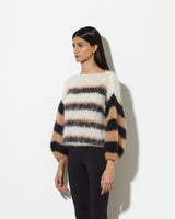 Model from the side wearing Sweater with stripes in creme black.