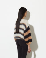 Model from the back wearing Sweater with stripes in creme black.