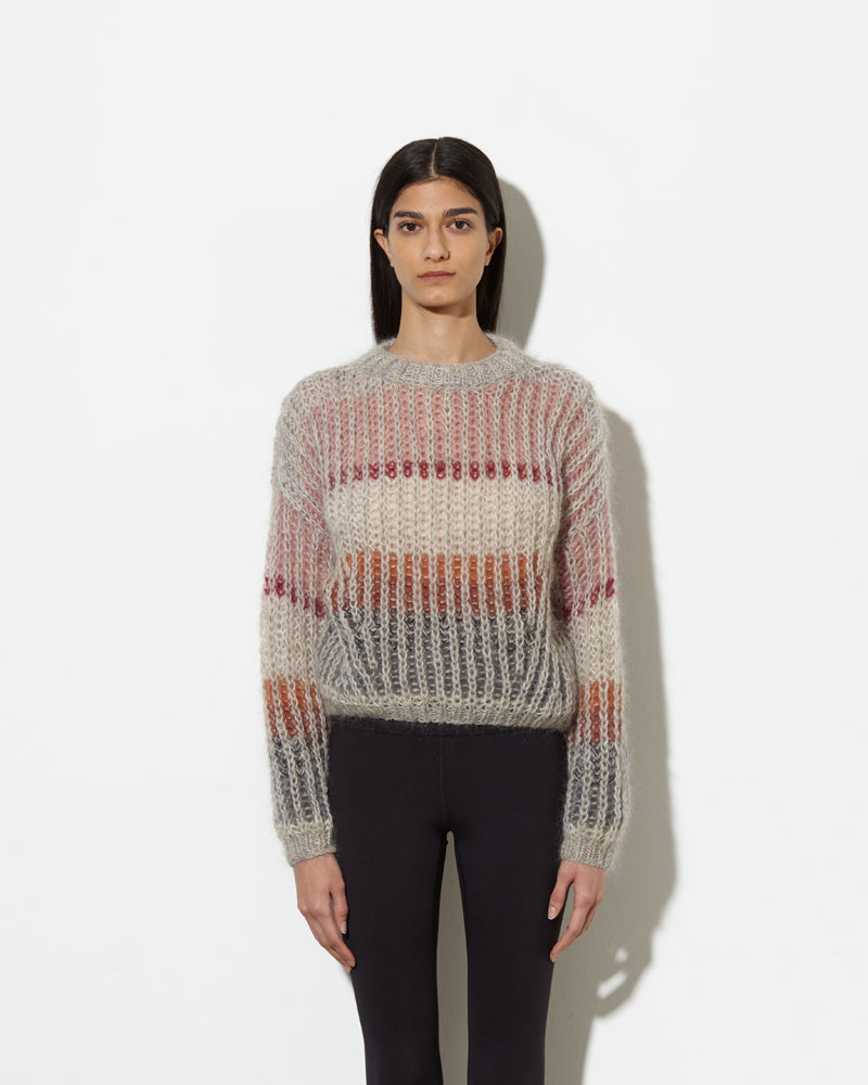 model wearing striped mohair sweater in muted. soft and cozy feel.