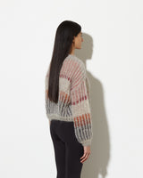 model from the back wearing striped mohair sweater in muted. soft and cozy feel.