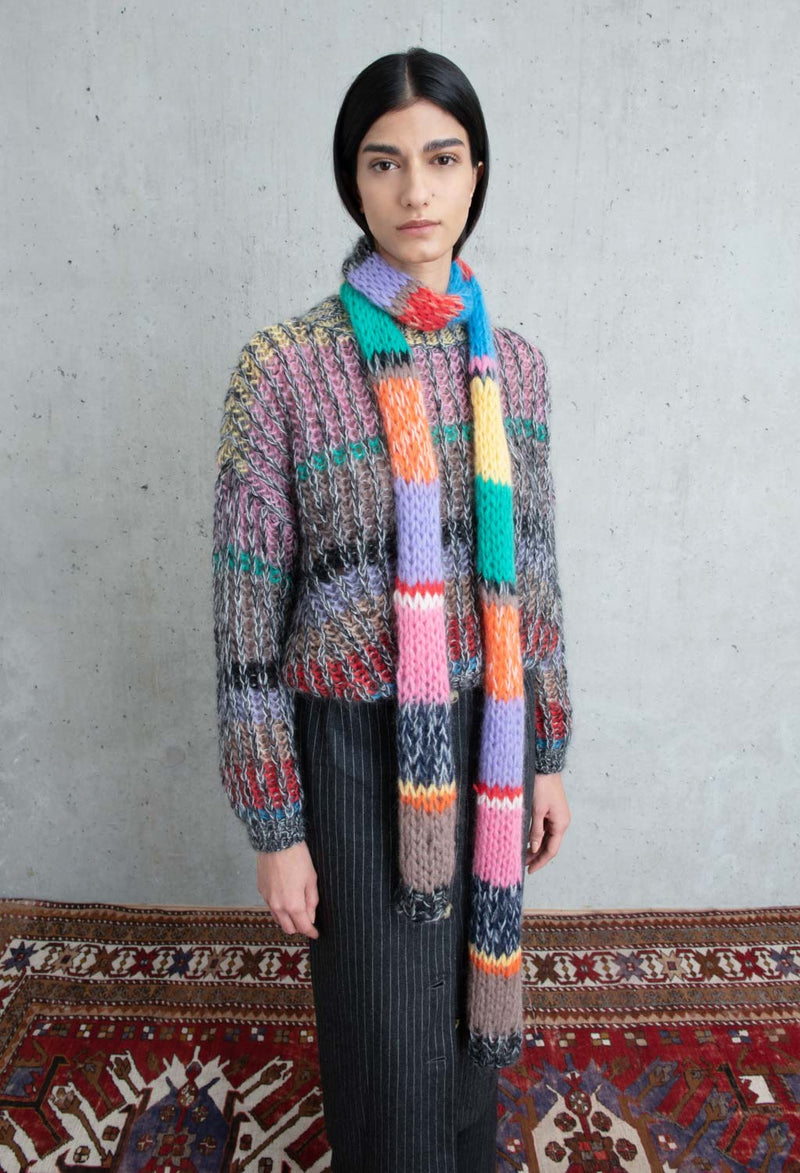 model wearing scarf and striped mohair sweater in primary. soft and cozy feel.