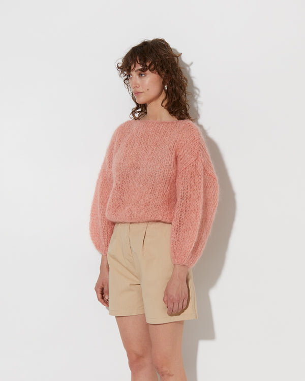 model wearing the spring mohair sweater in rosa. Shot from the side