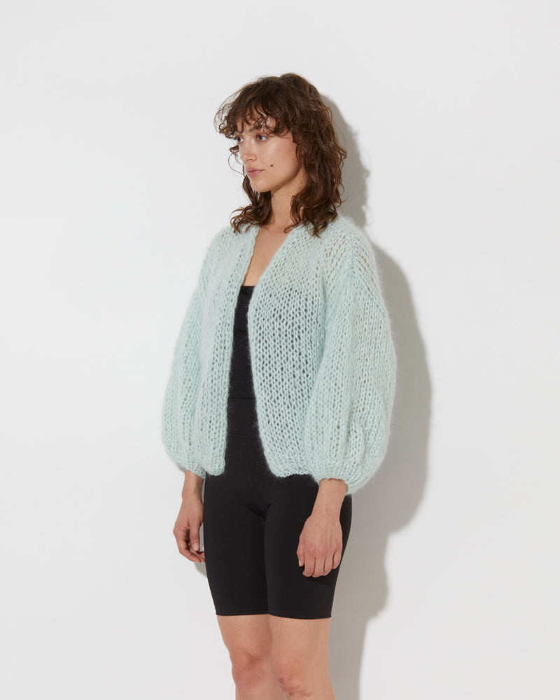 model wearing the spring mohair big bomber cardigan in mint. Shot from the side